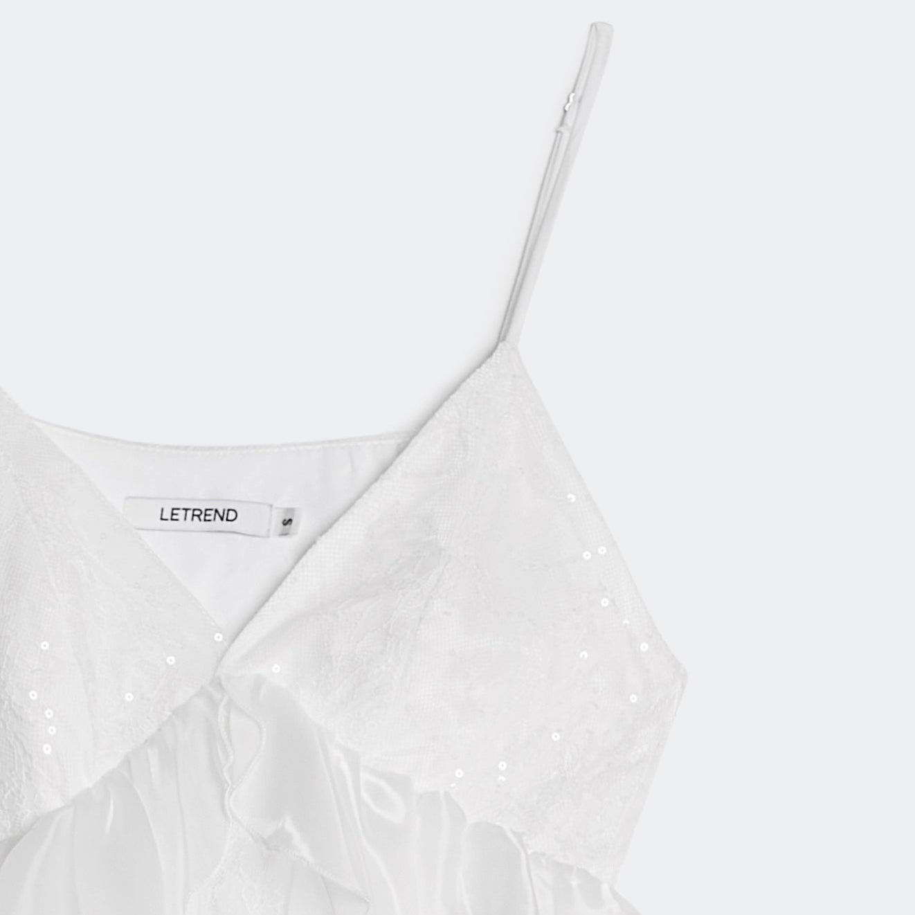 White dress with thin straps on a white background, featuring the brand 'LETREND'.