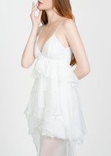 Woman wearing a white dress against a white background