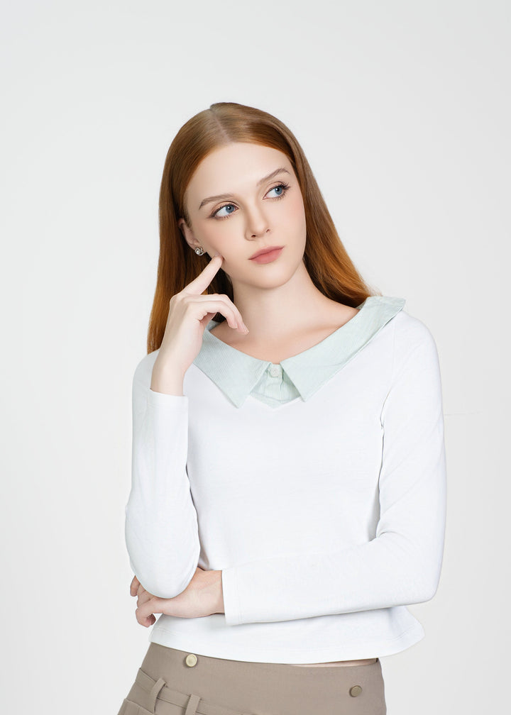 Woman wearing a white blouse and beige pleated skirt on a white background